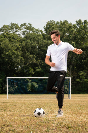 ATHLETE WEARING JDM ACTIVE WORKOUT PANTS WHILE PLAYING SOCCER