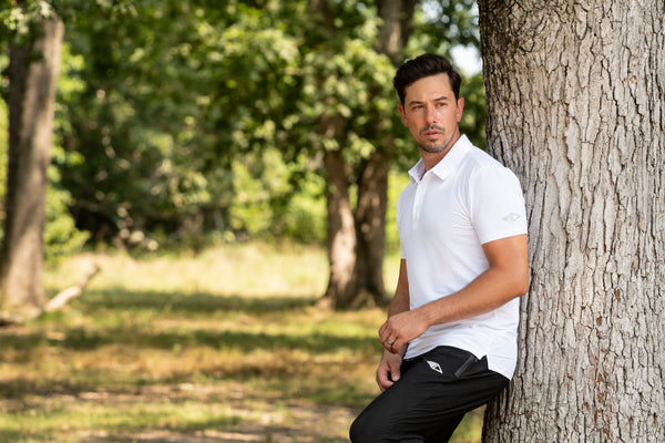 ATHLETE WEARING JDM ACTIVE WHITE STRETCH POLO